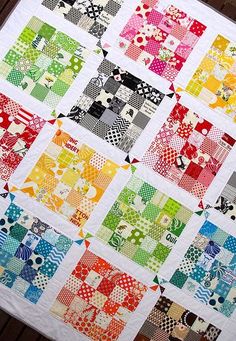 a close up of a colorful quilt on a table