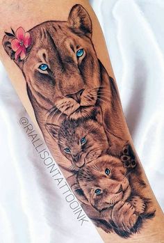 a lion and cubs tattoo on the left arm, with blue eyes in front of it