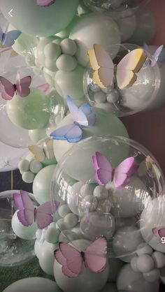 balloons and butterflies are floating in the air