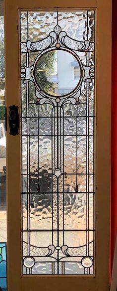 a glass door with an ornate design on it