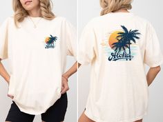 This stylish beach shirt is perfect for celebrating your holiday dreams and summer vacations. It's a comfortable and stylish option to wear at the beach during your summer vacation, on nature hikes, or any outdoor activity. M A T E R I A L S → All our simple color ones like White and Black are 100% Cotton. → All our Heathered Colors are cotton/polyester blend and they are super comfy soft! → Short Sleeve Crew-Neck Unisex T-Shirt → Soft and High-Quality Fabric → Sueded Jersey → Pre-shrunk → Taped shoulder-to-shoulder → Tear away label → Side Seamed → Retail fit S I Z E → We have size chart on our listing photos. S H I P P I N G & P R O D U C T I O N T I M E → Production time is 1-3 business days (depending on proof approval). → Shipping Time is 1-5 Business Days. → If you are in a RUSH, Ple Trendy Relaxed Fit Camp Shirt For The Beach, White Relaxed Fit Camp Shirt For Vacation, Summer Camp Shirt With Palm Tree Print Relaxed Fit, Relaxed Fit Beachy Hawaiian Shirt For Vacation, White Graphic Print Shirt For Vacation, Relaxed Fit Summer Camp Shirt For Vacation, Summer Camp Shirt With Palm Tree Print, White Vacation Tops With Palm Tree Print, White Palm Tree Print Top For Vacation