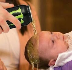 a baby is being washed with soap from a bottle