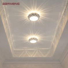 the lights are shining on the ceiling in the room with white walls and flooring