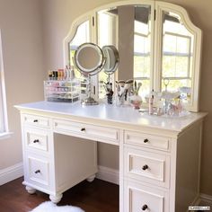 a white vanity with lots of makeup on it