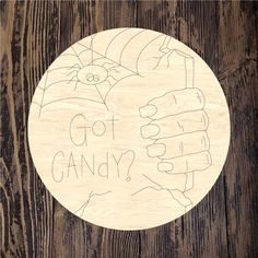 a wooden plaque that says, go to candy? on top of a wood background