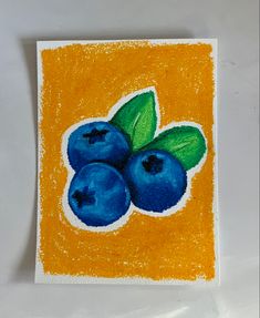 a drawing of blueberries with green leaves on an orange square background, in pastel and crayon