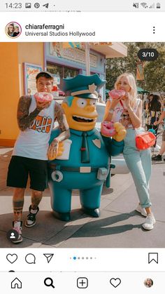 two people standing in front of a giant cartoon character with donuts on their hands