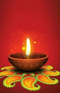 a lit candle in a bowl on top of a red surface with an intricate design