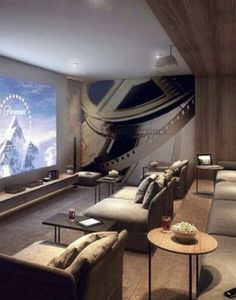 an image of a living room setting with couches and large screen tv on the wall