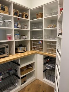 an organized pantry with lots of shelves and baskets