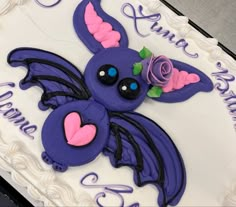 a birthday cake decorated with purple and pink icing