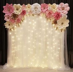 the backdrop is decorated with flowers and lights