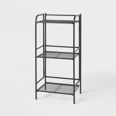 a black metal shelf with three shelves on each side