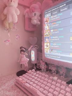 there is a pink computer with teddy bears on the wall and other stuff animals hanging above it