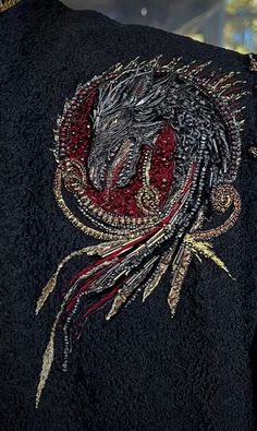 an embroidered jacket with a dragon on it