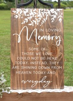 a wooden memorial sign with the words in loving memory