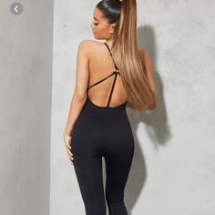 Brand New With Tags Stretch Backless Bodysuit For Loungewear, Solid Color Backless Bodysuit For Loungewear, Black Stretch Jumpsuits And Rompers With Seamless Construction, Fitted Backless Jumpsuits And Rompers For Loungewear, Backless Seamless Bodysuit For Workout, Fitted Backless Jumpsuit For Loungewear, Backless Seamless Workout Bodysuit, Backless Bodysuit For Gym, Backless Workout Bodysuit