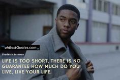 a man standing in front of a building with a quote on it that says life is too short, there is no guarantee how much do you live your life