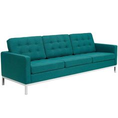 a teal colored couch sitting on top of a white floor