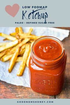 a jar filled with ketchup next to french fries