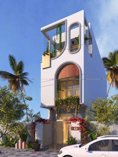 a white car parked in front of a tall building with plants on the balconies