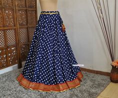 Made to Order/Made to Measurement/Custom Made Indian Lehenga Skirt (PLEASE NOTE THIS IS SKIRT ONLY) - Fabric: Polyester - Color : Navy Blue With Polka Dot Print - Fully Flared (8mtr) Kalidaar (Paneled)  Skirt - Lined - Red and Gold Banarasi Border - Drawstring closure with latkans This is Made To Order and we require following measurements in inches. 1. Waist of Skirt 2. Length of Skirt PLEASE NOTE: BUYERS ARE RESPONSIBLE FOR ANY CUSTOMS AND IMPORT TAXES THAT MAY APPLY. Fabric Care : Dry Clean Only Disclaimer: The actual color of the product might slightly differ from the image due to photographic lighting or monitor's display Shipping: This is made to order product. We customize the pattern of the dress to suit your style and fitting. Once you place the order we will provide you with a te Festive Blue Wedding Skirt, Traditional Fitted Tiered Lehenga, Festive Long Blue Skirt, Fitted Tiered Skirt For Festive Occasions, Traditional Blue Wedding Skirt, Festive Fitted Tiered Skirt, Blue Fitted Skirt For Festive Occasions, Blue Fitted Festive Skirt, Festive Fitted Blue Skirt