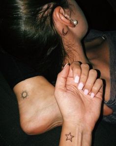 a woman with two small stars on her left wrist and the other half of her arm