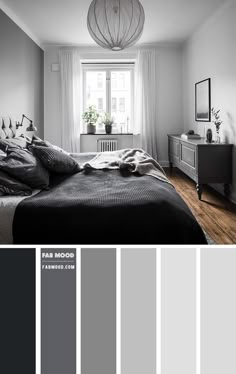 a bedroom with gray and white walls, wood flooring and wooden furniture in it