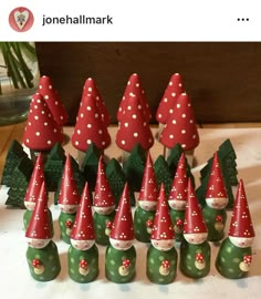 a group of gnomes with red hats and polka dots on their heads are lined up in rows