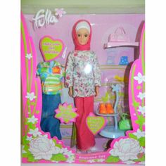 the doll is wearing a hijab and standing in front of a pink box