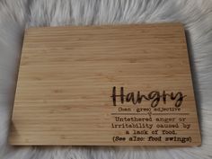 a wooden plaque that says hangry with an interesting quote on the front and bottom