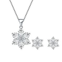 Capture the enchantment of a winter wonderland with our Austrian Crystal Bridal Snowflake Necklace & Earrings Set in clear silver-tone. Designed to evoke the ethereal beauty of freshly fallen snow, this set exudes timeless elegance and sophistication. Each piece is meticulously adorned with shimmering Austrian crystals, meticulously arranged to form delicate snowflake motifs. The clear crystals sparkle like ice in the sunlight, casting a spellbinding aura that captivates all who behold them. The necklace, suspended from a graceful silver-tone chain, drapes elegantly around the neck, drawing attention to its intricate craftsmanship and radiant allure. Paired with matching earrings, these pieces create a harmonious ensemble that complements any bridal gown or formal attire. Whether worn on y Wood Inlay Rings, Snowflake Necklace, Crystal Snowflakes, Snowflake Pendant, Women's Jewelry Sets, Sterling Silver Stud Earrings, Earrings Crystal, Ring Pendant Necklace, Silver Stud Earrings