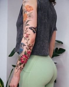 a woman with tattoos on her arm and leg