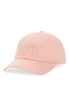 a pink hat with the word tokyo embroidered on it