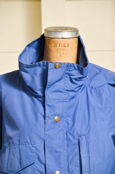 "1980s Parka Eddie Bauer Royal Blue Anorak Hooded Mountain Windbreaker Jacket YKK zip and EB brass snap closures. Removable hood. Drawstring waist. Four front pocket design. Shows normal signs of wear. Size is missing, fits like a Large. Please refer to measurements. Measurements Shoulders: open Chest: 50\" Sleeve: 20.5\" Length: 31\"" Urban Blue Windbreaker With Double-lined Hood, Vintage Hooded Jacket For Outdoor Activities, Streetwear Hooded Parka With Storm Flap, Urban Blue Windbreaker With Double Hood, Vintage Blue Windbreaker For Outdoor Activities, Urban Blue Parka With Pockets, Urban Blue Windbreaker With Adjustable Hood, Vintage Parka With Drawstring Hood For Outdoor, Vintage Outdoor Parka With Drawstring Hood