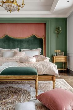 a bedroom with green walls and pink headboard, white bedding, gold trimmings