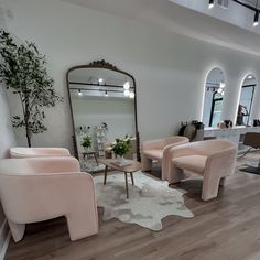 a living room filled with furniture and a large mirror