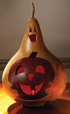 a wooden carved pumpkin sitting on top of a table