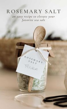 rosemary salt in a glass jar with a wooden spoon next to it and a tag that reads rosemary salt an easy recipe to create your favorite sea salt