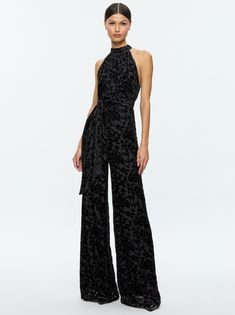 Shop the stylish THELMA Jumpsuit in Romance Black – a perfect blend of elegance and comfort. This chic black jumpsuit features a flattering fit, making it ideal for both casual and dressy occasions. Whether you're attending a party or enjoying a night out, the THELMA Jumpsuit is your go-to outfit for a polished, modern look. Elevate your wardrobe with this must-have piece today! Halter Neck Jumpsuit, Velvet Burnout, Alice And Olivia, Halter Neckline, Black Jumpsuit, Alice Olivia, Hip Length, Halter Neck, Neck Tie