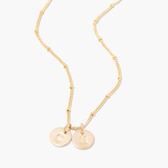 No matter where you are going, deck your neck with our classic Madeline two initial pendant. We love its delicate design and versatility. Rock it alone or as the base of an on-trend layered look. 3/8" 14k gold plated brass, rhodium plated brass or rose gold filled disc Hand stamped initial 16" brass satellite chain with 2" extender Lobster claw closure With customization this item is FINAL SALE NOTE - discs DO NOT slide on and off the chain. If you are looking to add or remove discs from the cha Everyday Rose Gold Initial Necklace With Adjustable Chain, Everyday Rose Gold Initial Pendant Necklace, Dainty Adjustable Initial Necklace For Everyday, Delicate Rose Gold Initial Necklace For Everyday, Rose Gold Initial Pendant Necklace With Delicate Chain, Adjustable Rose Gold Charm Necklace With Initial Pendant, Dainty Rose Gold Initial Necklace With Charms, Dainty Initial Pendant Necklace For Layering, Rose Gold Sterling Silver Initial Necklace With Delicate Chain