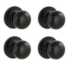 four black door knobs with round handles