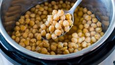 a spoon full of chickpeas in an instant pot