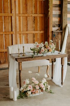 a table with flowers and candles on it