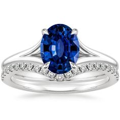 a blue sapphire and diamond ring set on top of each other with the band in white gold