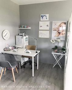 a room with a desk, chair and pictures on the wall