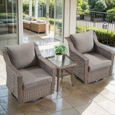 two chairs and a table on a patio