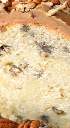 a close up of a cake on a plate with pecans and nuts around it