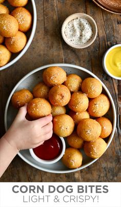 corn dog bites with ketchup and mustard on a plate next to dipping sauce