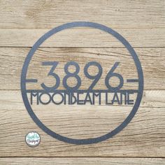 a wooden wall with a metal sign that reads3896 mooideatlane